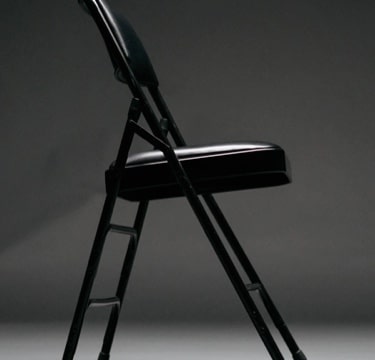An image of a chair and a plate on  a table